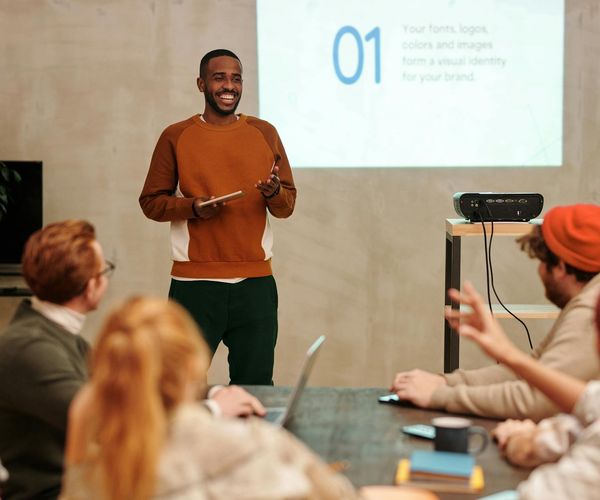 Diverse group of people smiling in a bright room.